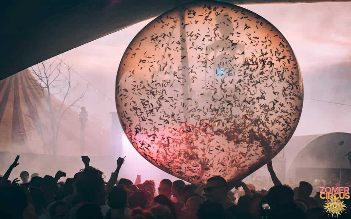 Giant confetti ball balloon above festival crowd at sunset at Zomer Circus in Amsterdam (2019) — Master Blaster