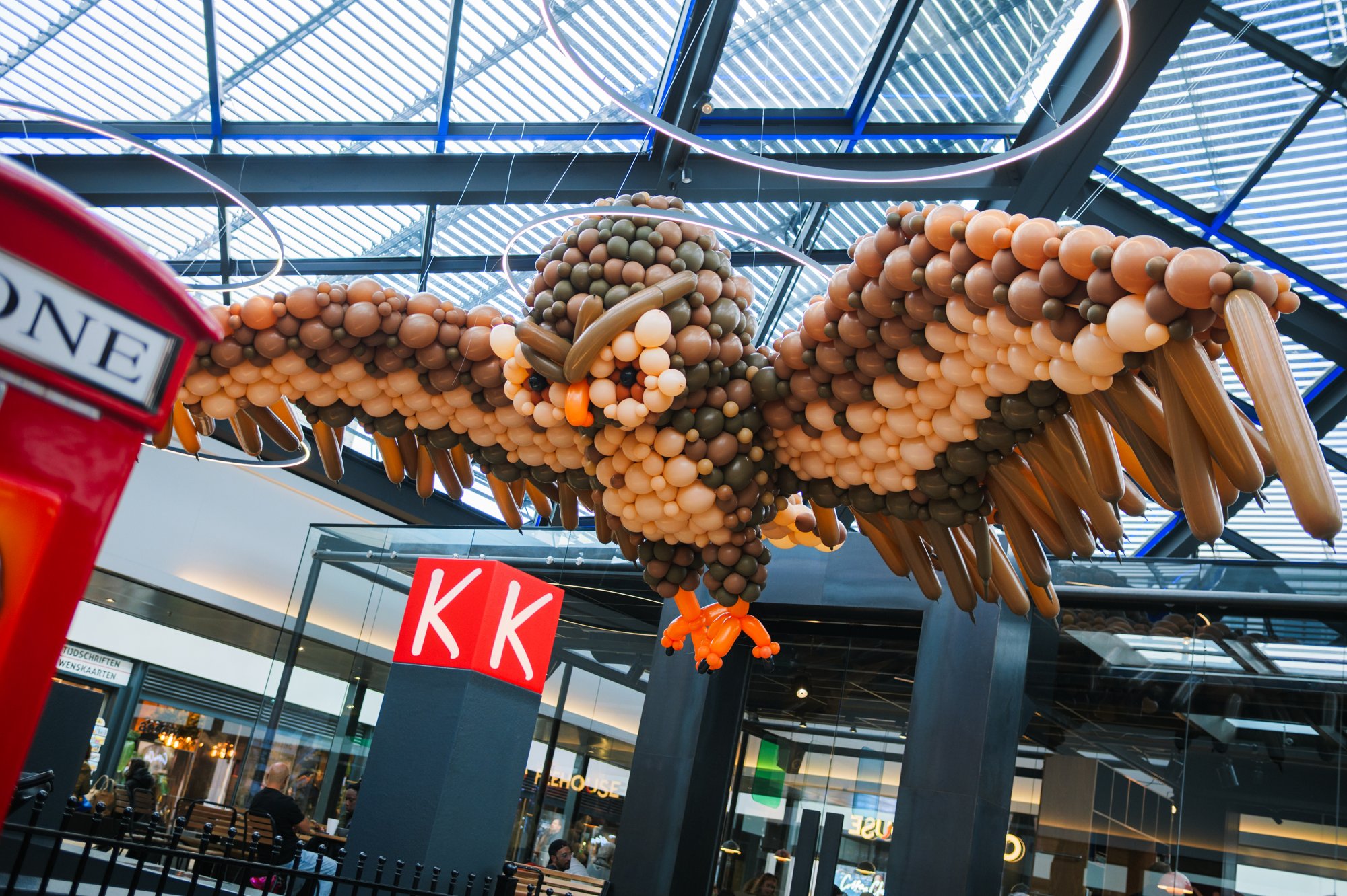 Giant balloon owl under the glass roof of Gelderlandplein (2026) — Design: Gijs de Smed — Photo: zestien:negen
