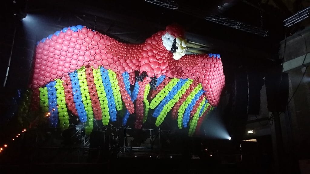 Giant illuminated parrot balloon sculpture at Apenkooi indoor festival — Stages of Air — Out of Thin Air