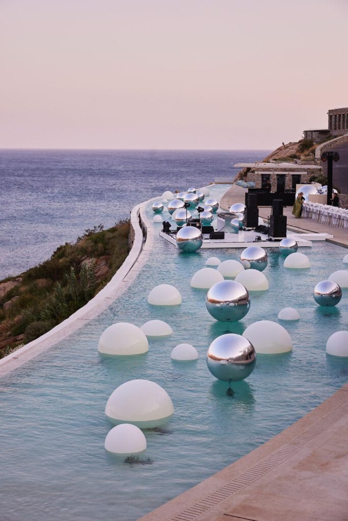 Chrome LED Orbs — Mykonos 2025 | Out of Thin Air Chrome LED orbs reflecting in infinity pool at night in Mykonos — private event via 8 The Agency — Out of Thin Air
